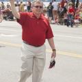 Jim Brannon, Kootenai County Clerk, hands out free American Flags along the parade route - Photo courtesy of 29k Productions