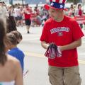 KCRCC Treasurer Doug Balija hands out flags at the parade - Photo courtesy of 29k Productions