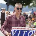 A man carries a sign in the Coeur d'Alene parade supporting Vito Barbieri - Photo courtesy of 29k Productions